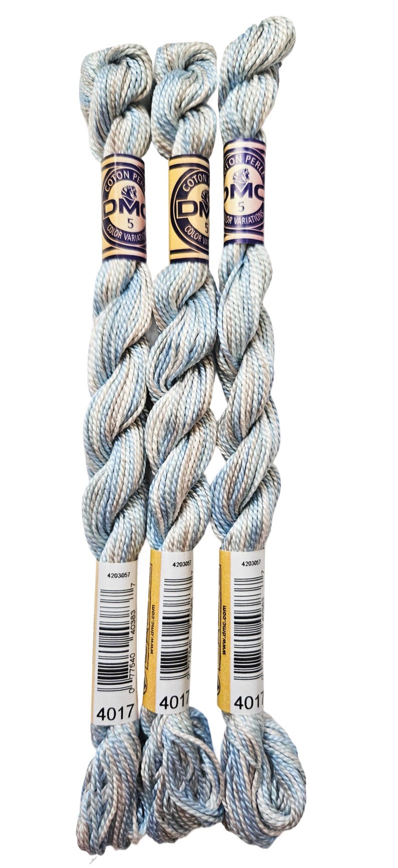 three skeins of yarn sitting on top of each other