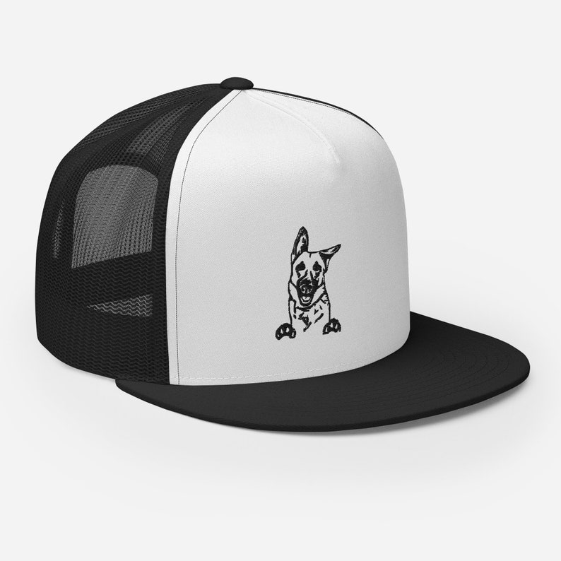 May include: A black and white illustration of a German Shepherd dog peeking out from behind a white and black trucker hat. The hat has a black mesh back and a white front.