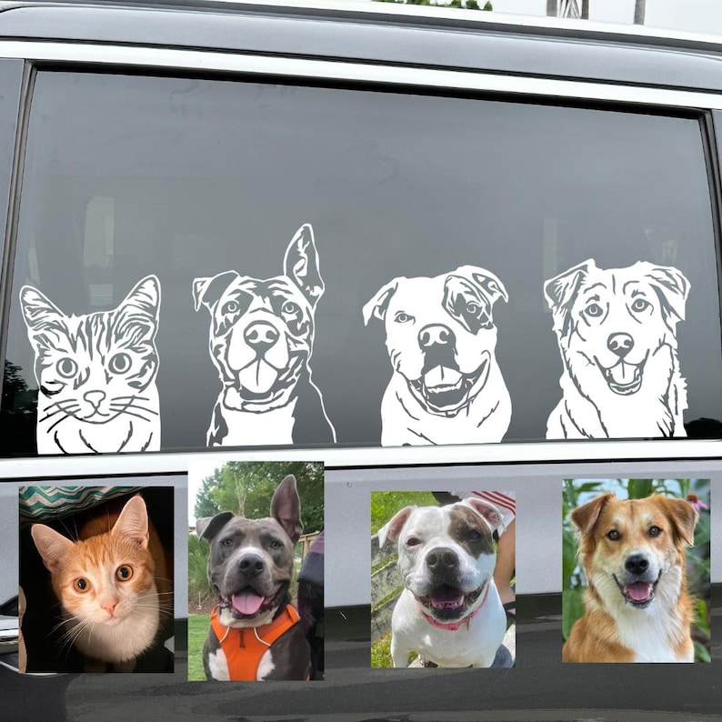 May include: A car window with five white silhouette decals of a cat and four dogs. The cat is on the left side of the window, and the dogs are on the right side. The decals are all smiling.