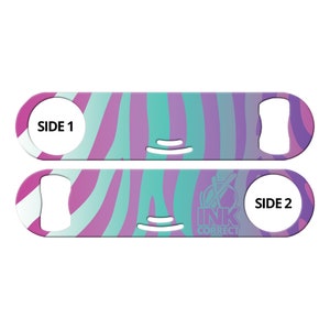 May include: A pink and teal zebra patterned bottle opener with a side labeled "SIDE 1" and the other side labeled "SIDE 2" with the text "INK CORRECT" in a circle with a diagonal line through it.
