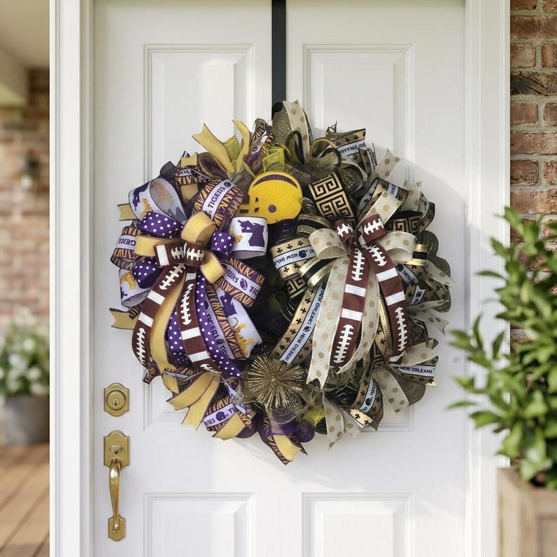 May include: A decorative wreath with football-themed ribbons in purple, gold, and brown. The wreath includes a miniature yellow football helmet and ribbons with football and team-related text.