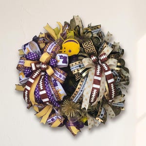 May include: A decorative wreath featuring ribbons in purple, gold, and brown, with football and tiger-themed accents. Includes a yellow football helmet and text that reads "Tigers" and "New Orleans".