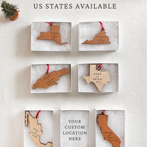 May include: Wooden ornaments in the shape of US states and countries, each with names and dates, presented in individual boxes. The text "ALL COUNTRIES AND US STATES AVAILABLE" is at the top. One box is blank, with the text "YOUR CUSTOM LOCATION HERE".