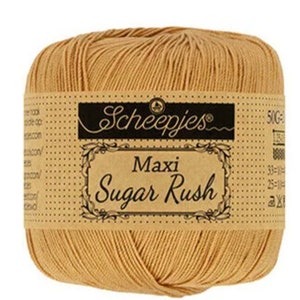 May include: A ball of tan yarn labeled "Scheepjes Maxi Sugar Rush" with a brown and white label.