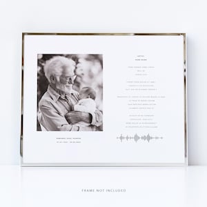 May include: A black and white photograph of an older man holding a baby. The photo is in a silver frame with a white mount. The text "Artist: Song Name" is at the top of the frame. The text "Your chosen song lyrics will be added here" is below the artist and song name. The text "Edwards (Dad) Harris 01.21.1964 - 06.04.2023" is at the bottom of the frame.