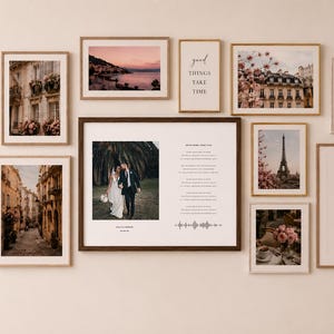May include: A collection of framed art prints and photographs, including floral, architectural, and landscape scenes. One frame features a wedding photo with text. Other prints include inspirational quotes and the Eiffel Tower.