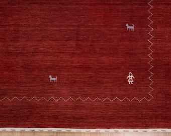 May include: A red rug with a textured surface and a white zigzag border. The rug features small embroidered figures of animals and people. The rug's color is a deep, warm red, and the design is simple and elegant.