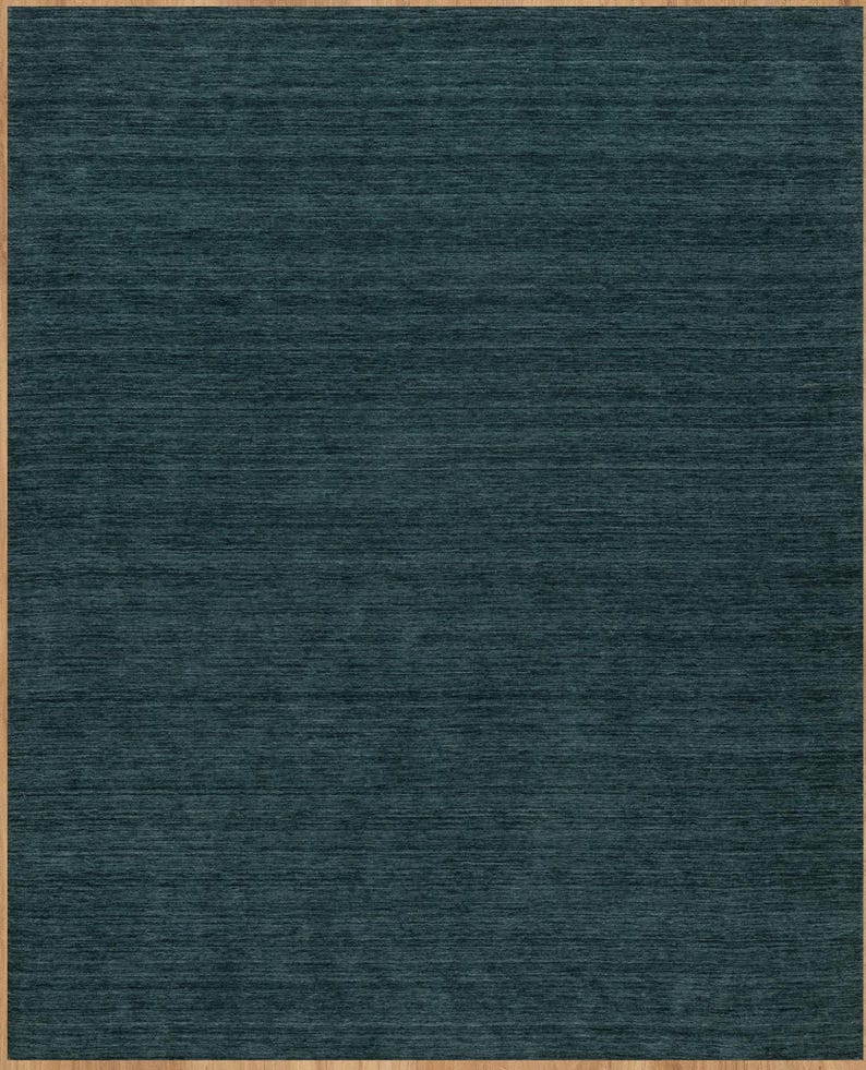 8x10 area rug in dark forest green. The solid color rug is handknotted in high quality NZ wool.