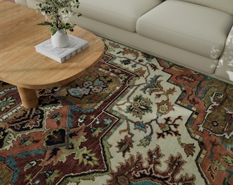 May include: A cream-colored rug with a traditional Persian design in shades of red, blue, green, and brown. The rug is laid out on a wooden floor in a living room setting.
