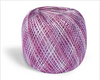 May include: A ball of purple and white yarn with a metallic sheen.