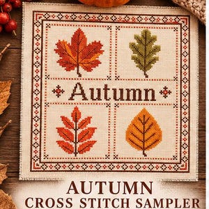 May include: A square cross stitch sampler on cream fabric featuring a decorative border and four quadrants, each displaying a different autumn leaf in red, green, orange, and yellow. The word Autumn is stitched in brown in the centre.