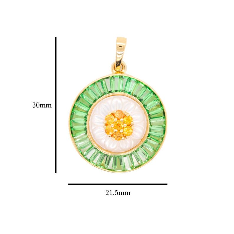 May include: A gold-toned pendant with a daisy design. The pendant features a white center with orange accents, surrounded by a ring of green baguette-cut stones. The pendant is 30mm in length and 21.5mm in width.