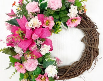 Bright colorful pink Spring floral wreath with roses and carnations for front door