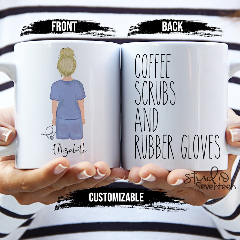 May include: White ceramic coffee mug with a cartoon illustration of a person wearing blue scrubs and holding a stethoscope. The text "Elizabeth" is printed below the illustration. The back of the mug has the text "Coffee Scrubs and Rubber Gloves" printed on it.