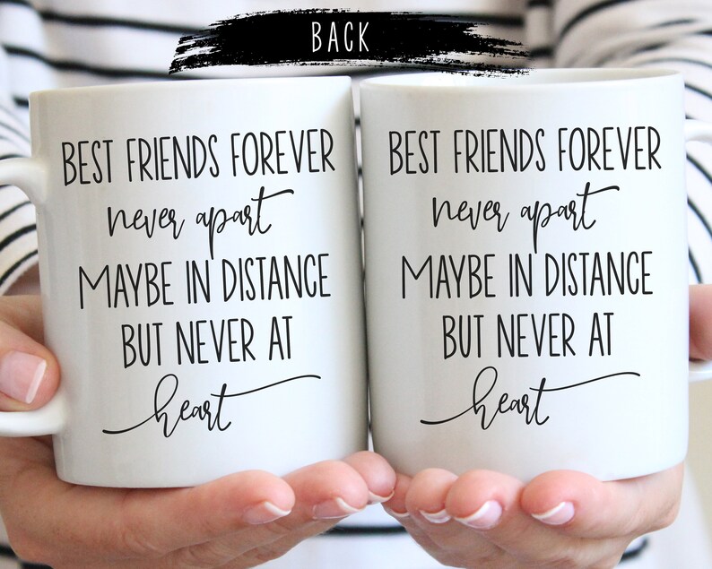 May include: Two white coffee mugs with black text that reads "Best friends forever never apart maybe in distance but never at heart".
