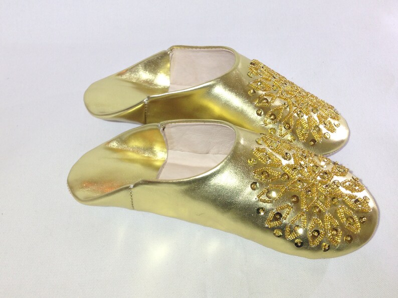 gold and white slippers
