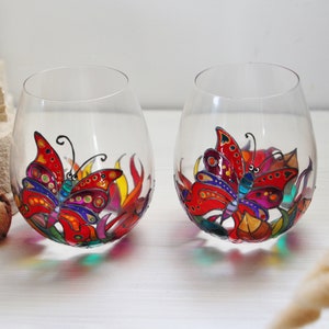 Duo of two very colorful hand painted boho crystal whiskey glasses decorated with a customizable rainbow butterfly
