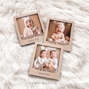 May include: Three wooden photo frames with images of babies dressed in bunny costumes. The frames have engraved text that says "our little bunny Easter 2025", "hoppy easter!" and "our first easter Easter 2025".