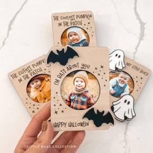 May include: Wooden Halloween photo frames with bat and ghost cutouts. The frames feature photos of children and the phrases "The Coolest Pumpkin in the Patch", "The Cutest Pumpkin in the Patch", "I'm Bats About You", and "My Little Boo!" are written on them.