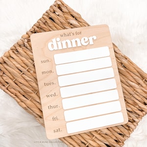 May include: A rustic wooden sign with the text "Welcome to our home" in white lettering. The sign features a distressed finish and a simple, inviting design, perfect for front door decor.
