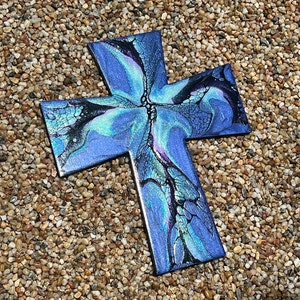 May include: A blue and black cross with a marbled paint design. The cross is made of wood and has a glossy finish.