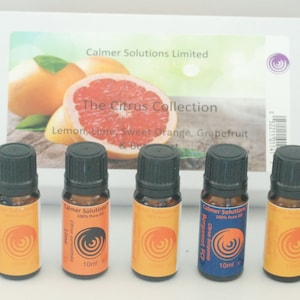 May include: A set of five 10 ml amber glass bottles with black caps containing essential oils. The bottles are labelled with the names of the oils: Lime, Bergamot FCF, Sweet Orange, Grapefruit, and Lemon. The bottles are arranged in a row on a white surface. The Citrus Collection is written on a box in the background.