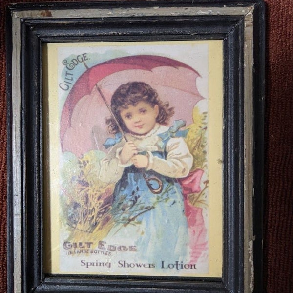 Reproduced Vintage Advertisement Girl with Umbrella Gilt Edge Spring Shower Lotion in Distressed Frame