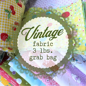 May include: A close-up of a variety of colorful fabric scraps in a grab bag. The bag contains 3 pounds of vintage fabric. The fabric is a mix of patterns and colors, including floral, polka dot, and plaid.