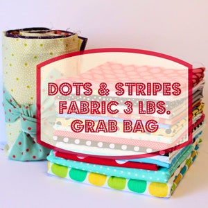 May include: A stack of colorful fabric scraps in a variety of polka dot and striped patterns. The fabric is labeled "Dots & Stripes Fabric 3 lbs. Grab Bag".