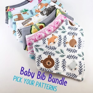 May include: A stack of seven baby bibs with various animal and floral patterns. The bibs are made of soft, absorbent fabric and are perfect for keeping baby's clothes clean. "Baby Bib Bundle PICK YOUR PATTERNS" is written in blue and teal text at the bottom of the image.