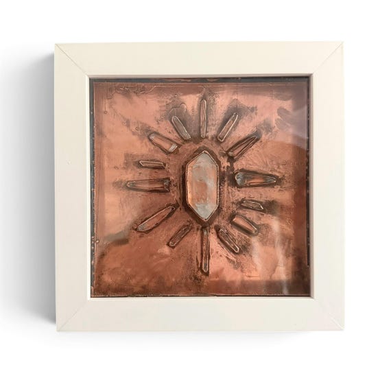 Real quartz crystals electroformed in copper into a sunburst wall sculpture — a genuinely unusual process that fuses geology and metalsmithing into something that looks like it escaped a Victorian curiosity cabinet.