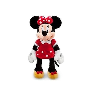 May include: A plush Minnie Mouse doll. The doll has black ears, a red and white polka dot bow, and a red dress with white polka dots. The doll has white gloves, black legs, and yellow shoes with red bows. The doll is standing upright.