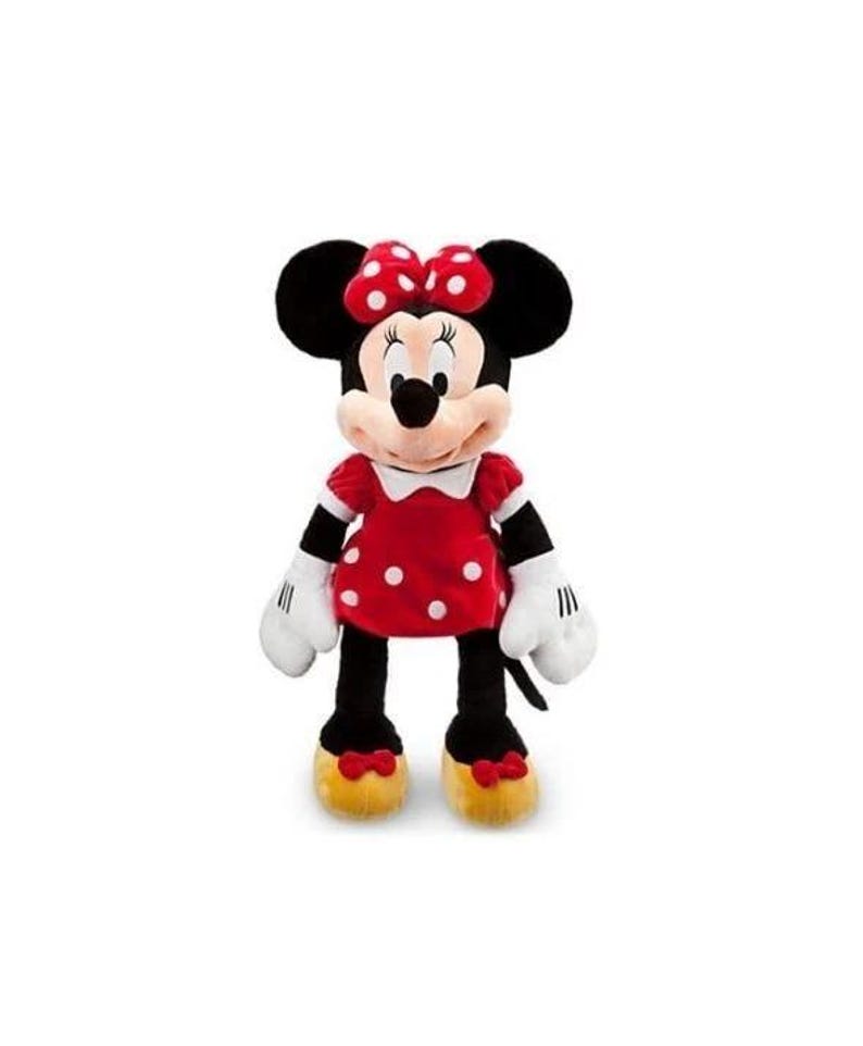 May include: A plush Minnie Mouse doll. The doll has black ears, a red and white polka dot bow, and a red dress with white polka dots. The doll has white gloves, black legs, and yellow shoes with red bows. The doll is standing upright.