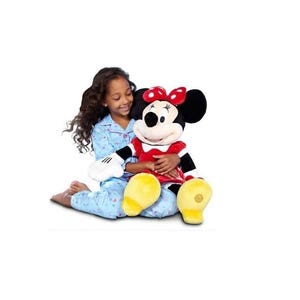 May include: A plush Minnie Mouse doll with a red dress, black and white striped sleeves, and a red bow. The doll has large yellow shoes and is being held by a person wearing blue pajamas with a star pattern.