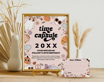 May include: A pink and brown time capsule sign with a ghost, pumpkin, and other Halloween-themed illustrations. The sign says "time capsule 20XX" and "To be opened on Willow's 18th Birthday". There is a pink card with the text "Dear Willow, Love," and lines for writing.