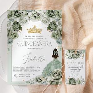 May include: Green and gold quinceañera invitation with a floral design and a crown. The invitation includes the text "MR. AND MRS. RODRIGUEZ INVITE YOU TO CELEBRATE THE QUINCEAÑERA OF THEIR DAUGHTER Isabella" and details for the event. A matching thank you tag with a floral design and the text "THANK YOU for coming and celebrating my special day with me! Isabelle" is also included.