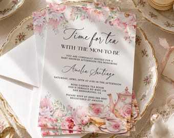 May include: A rectangular baby shower invitation card featuring a floral border of pink and white peonies. The text reads: Time for tea WITH THE MOM-TO-BE, YOU ARE CORDIALLY INVITED FOR A BABY SHOWER AFTERNOON TEA HONORING Amelia Santiago, SATURDAY, APRIL 20TH AT 4:00 IN THE AFTERNOON, ROSE GARDEN TEA ROOM, 1010 N TERRACE RD #SPC 136, SAN BERNARDINO, CA, PLEASE RSVP AT (909) 888-8007, REGISTERED AT AMAZON.