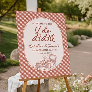 May include: A sign for an engagement party, featuring a red and white checkered pattern. The sign reads "Welcome to the I do BBQ, Lorel and Jason's Engagement Party! June 15, 20XX." An illustration of a grill and food is at the bottom.