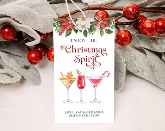May include: White gift tag with red and green floral border. The text reads "Enjoy the Christmas Spirit" in red cursive font. Three watercolor illustrations of cocktails are below the text. The bottom of the tag reads "Love, Ray & Georgina Smith-Anderson".