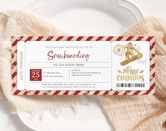 May include: A red and white striped gift voucher with gold snowflakes and a gold illustration of a snowboarder. The voucher is for snowboarding and says "Merry Christmas".