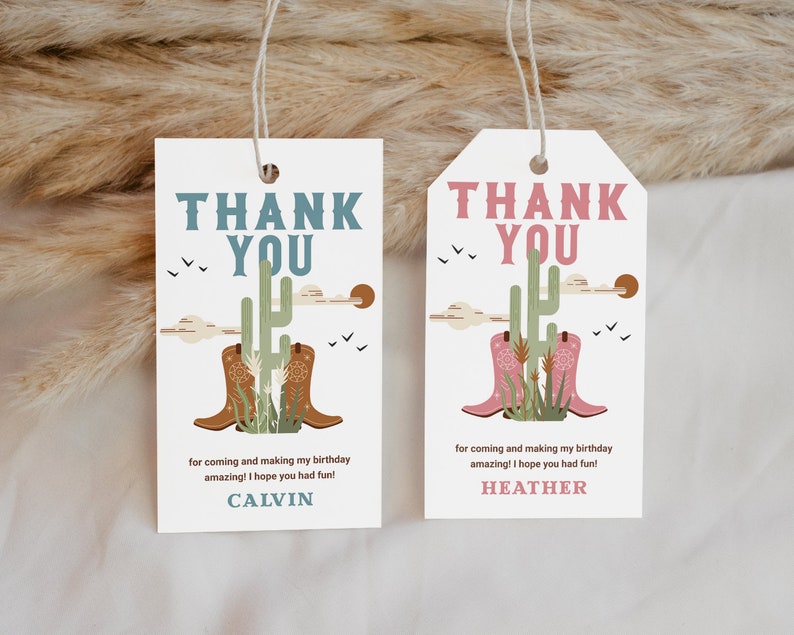 May include: Two thank you tags with a cactus and cowboy boots design. The text on the tags reads "Thank You" and includes the names "Calvin" and "Heather".
