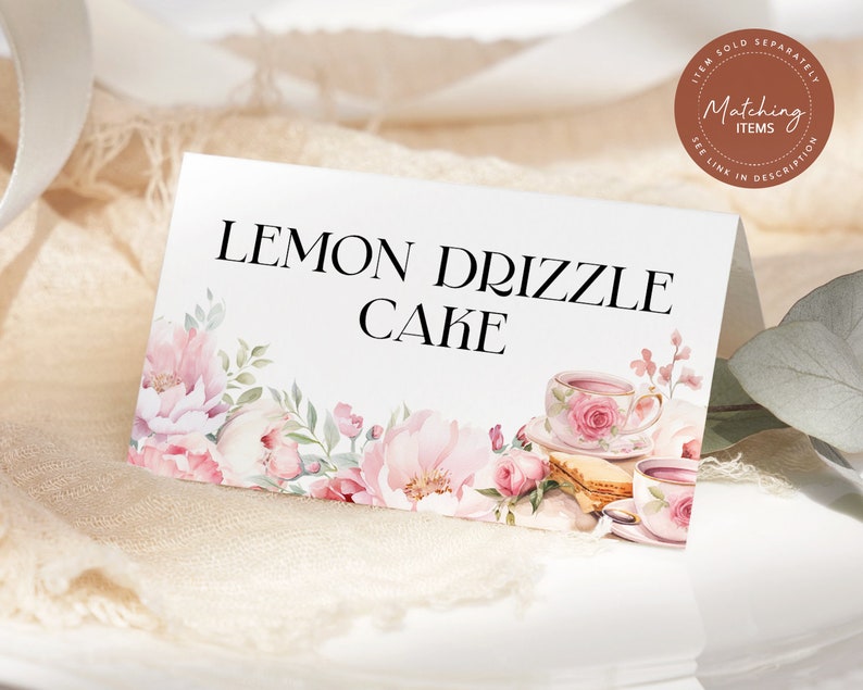 May include: White card with pink floral border and text "LEMON DRIZZLE CAKE". The card has a watercolor illustration of teacups and saucers with pink roses.