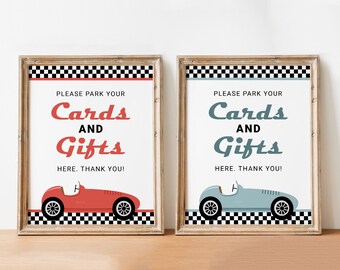 May include: Two signs with a checkered background and a vintage car graphic. The text on the signs reads "Please park your cards and gifts here. Thank you!"