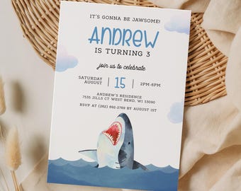 May include: A birthday party invitation with a shark illustration. The invitation has the text "IT'S GONNA BE JAWSOME!" and "ANDREW IS TURNING 3". The date is August 15th, 2 PM-6 PM. The invitation also includes the address and RSVP information.