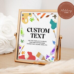 May include: A gold-framed sign with the words "CUSTOM TEXT" in bold black letters. The sign is decorated with colorful paint splatters, paint tubes, and brushes. The text below reads "USE THIS TEMPLATE TO CREATE YOUR OWN CUSTOM SIGNS. CHANGE FONT, COLORS, SIZES, ETC."