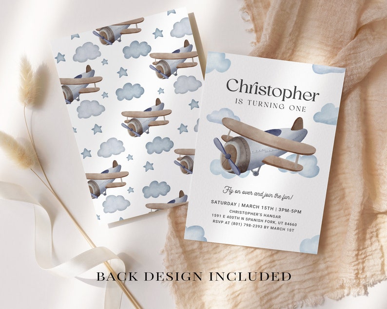 May include: A blue and brown airplane with clouds and stars on a white background. The text "Christopher is turning one" is at the top of the invitation. The text "Fly on over and join the fun!" is below the airplane. The text "Saturday March 15th 3PM-5PM" is below the text "Fly on over and join the fun!" The text "Christopher's Hangar" is below the date and time. The text "1541 E 400th N Spanish Fork, UT 84660" is below the hangar name. The text "RSVP at (801) 798-2393 by March 1st" is below the address. The text "Back Design Included" is at the bottom of the invitation.