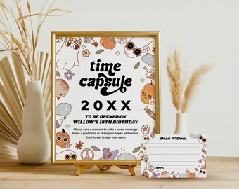 May include: A printable time capsule sign with a white background and colorful illustrations of pumpkins, ghosts, and other Halloween-themed imagery. The sign reads "time capsule 20XX TO BE OPENED ON WILLOW'S 18TH BIRTHDAY" and includes instructions for guests to write a message, prediction, or wishes for Willow. A matching card with lines for writing is also included.