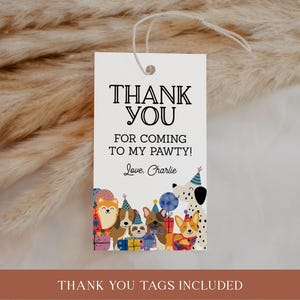 May include: A white gift tag with the text "THANK YOU" in black. Below, it reads "FOR COMING TO MY PAWTY! Love, Charlie." The bottom features cartoon dogs wearing party hats. The tag is strung with white twine.