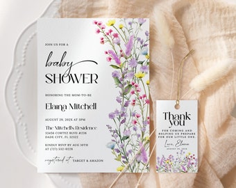 May include: A white baby shower invitation with a watercolor floral design featuring purple, pink, and yellow flowers. The invitation text reads "Join us for a baby shower honoring the mom-to-be Elaina Mitchell, August 29, 202X at 3PM, The Mitchell's Residence, 33456 Cortez Blvd #238, Dade City, FL 32322, Kindly RSVP by Aug 10th at (727) 532-0228, registered at Target & Amazon". A matching thank you tag with the same floral design reads "Thank you for coming and helping us prepare for our little one. Love, Elaina, August 29, 202X".