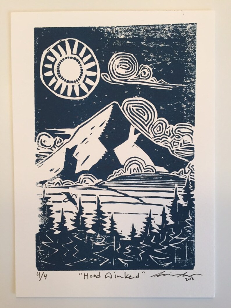 May include: A blue and white linocut print of a mountain scene with a sun, clouds, trees, and the text "Hood Winked" signed and numbered 4/4.